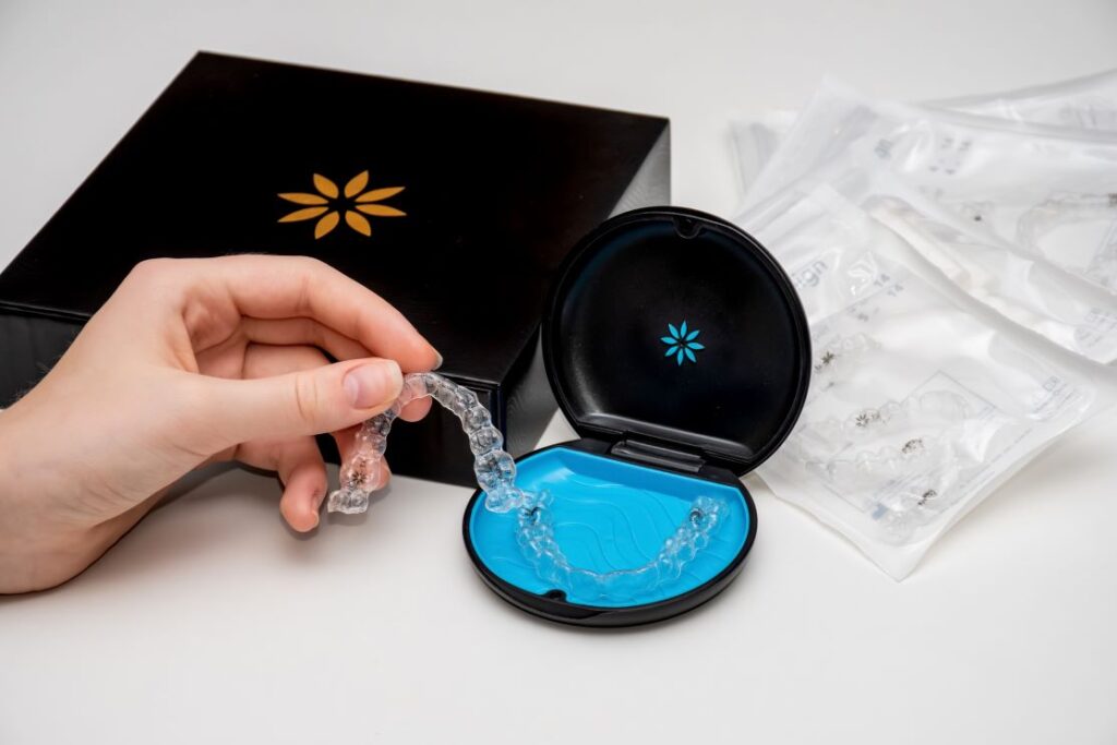 A person putting their Invisalign aligner in a storage case.